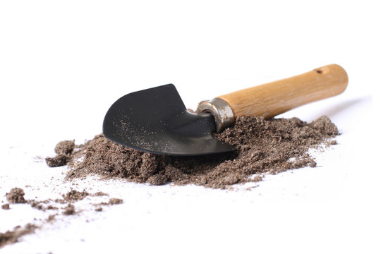 Little spade shovel isolated over a white background.