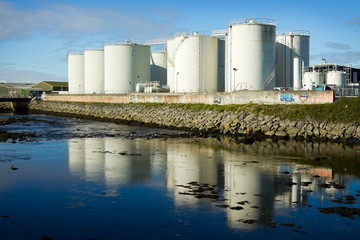 Fototapeta premium fuel tanks on the bank of the river