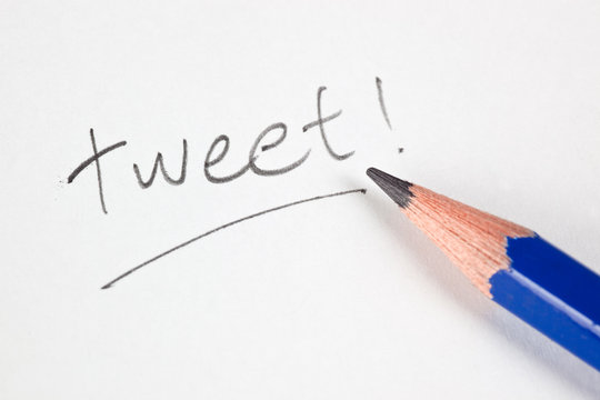 Pencil with the word TWEET on a piece of paper
