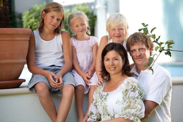 young parenst with three children close