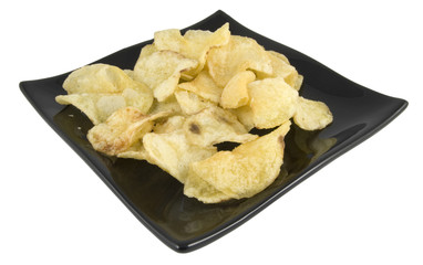 crisps on black plate isolated on white background