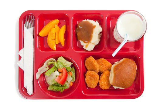 School lunch tray with food on it on a white backgrounf