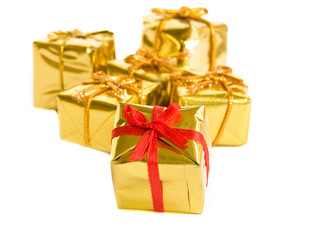 Small golden gifts, isolated over white Shallow DOF.