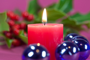 christmas decoration with candle light,holly leaves and berries