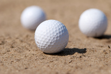 three golfballs On sand