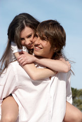 Young couple against the sky