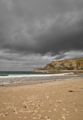 Dark clouds over Portreath beach, Cornwall UK.