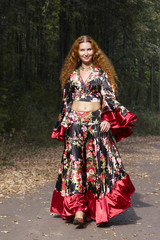 A beautiful ginger-haired girl in gipsy suit