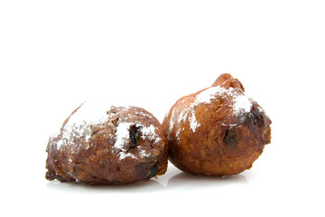 two Dutch donut oliebollen over white background