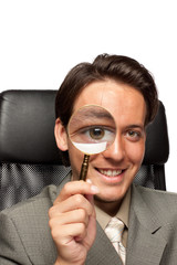 Young businessman with a magnifying glass