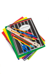 Spiral notebooks with school supplies on top