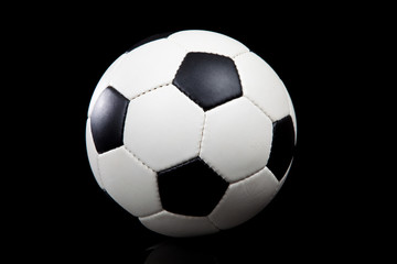 Naklejka premium Soccer ball on a black background