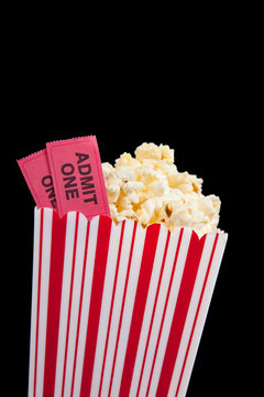 Movie ticket and popcorn on a black background