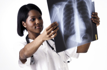 African American technician examining xrays