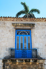 Old balcony with a palm tree in the background
