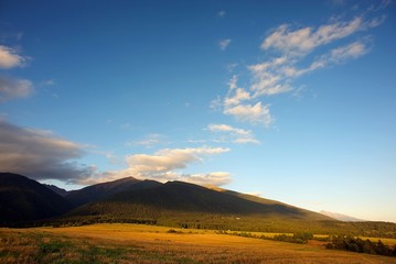 moutians in sunset with diagonally clouds