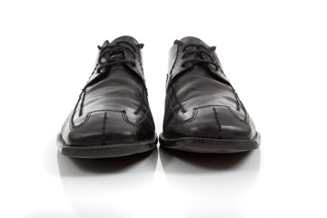Men's black dress shoes on a white background