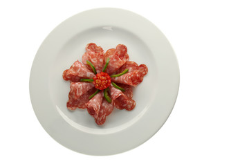 salami on white plate isolated