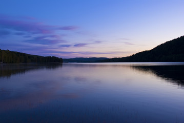 Fototapeta na wymiar Blue cold sunrise over lake in sweden
