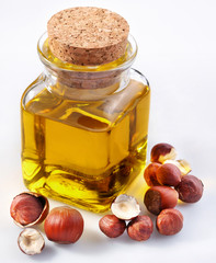 filbert oil with nuts on a white background