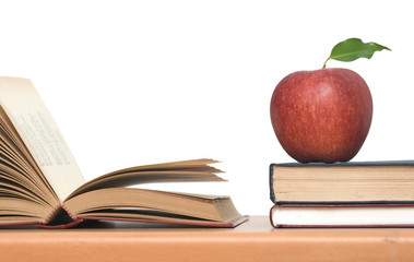 Red apple and books on desk