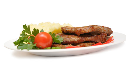 roasted meat with vegetables on white plate