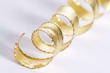 Golden curls ribbons on a white background