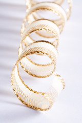 Golden curls ribbons on a white background