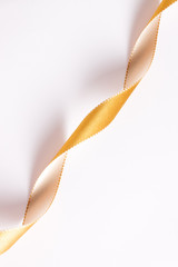 Golden curls ribbons on a white background