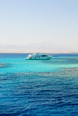 Yacht in sea with coral reefs