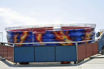 Detail of a Tagadà ride in motion in an amusement park