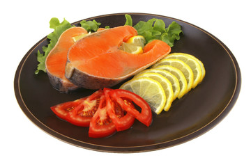 two salmon steak on dark dish