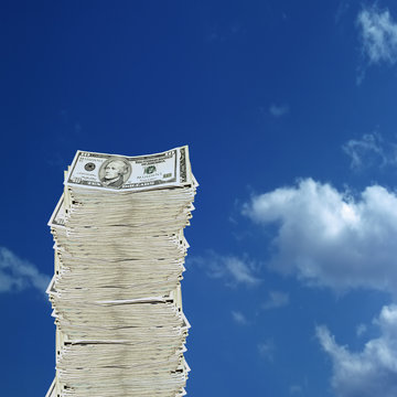 conceptual image of 10 dollar bill on blue sky background