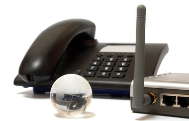 Office phone, wi-fi router and glass globe