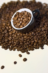 Coffee beans in the  black cup. Close up