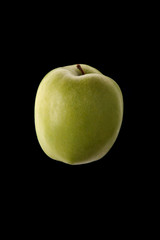 Green apple on black background