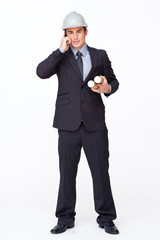 Attractive architect on phone holding plans