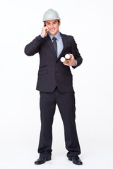 Smiling attractive architect on phone holding plans