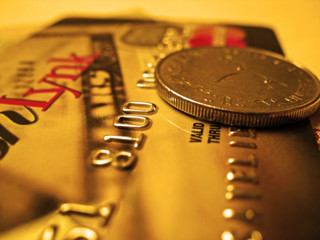 A golden credit card with a coin
