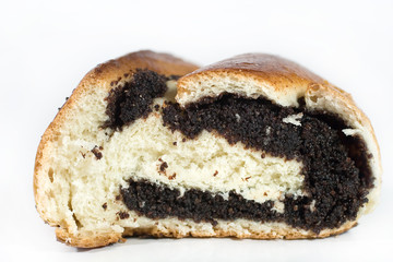 Closeup of a sliced roll with poppy seeds (on white)