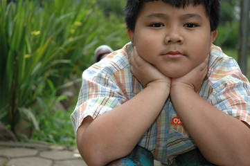 little boy get laying in the park