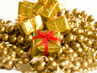 Small golden gift with red ribbon. Shallow DOF.