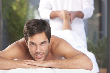 Healthy man relaxing at spa