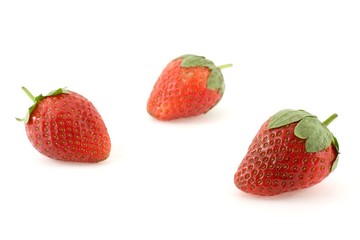 Three strawberries over white background
