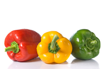 red, yellow and green pepper with water drops isolated on white