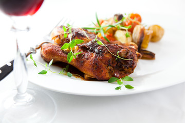 Roasted chicken with baked vegetables and red wine