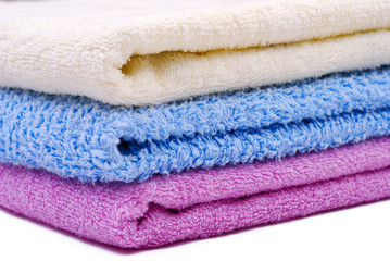 Stack of colorful towels on white