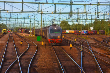 Fototapeta na wymiar Freight train passing railway station