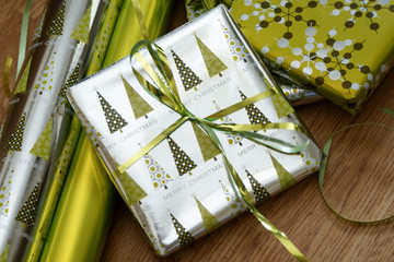 silver gift and rolls of paper
