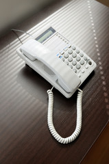 Telephone over brown desk